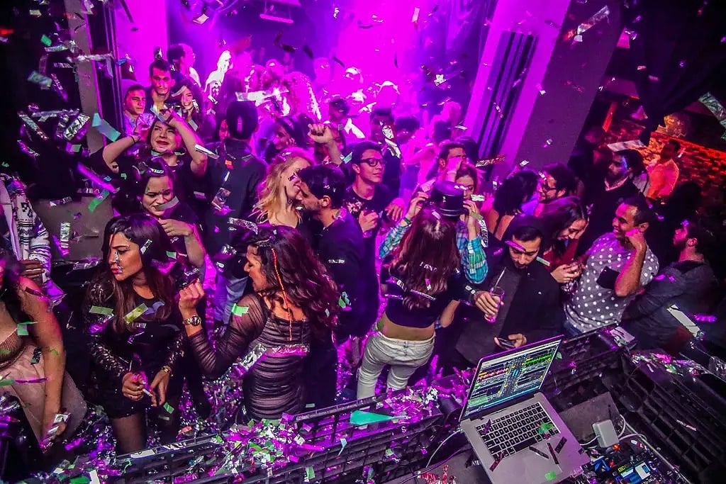 Crowd dancing and cheering at a lively club event in The Club HKV, Hauz Khas Village
