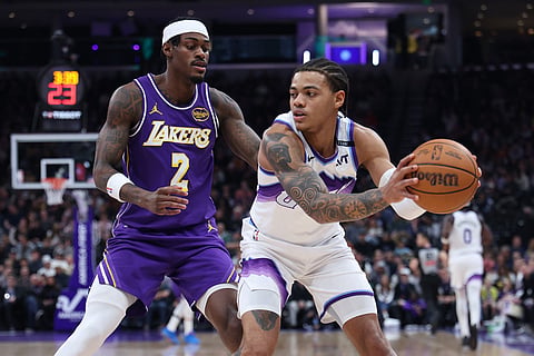 Utah Jazz guard Keyonte George, right, looks for a play against Los Angeles Lakers forward Jarred Vanderbilt (2) during the first quarter of an NBA basketball game in Salt Lake City. 