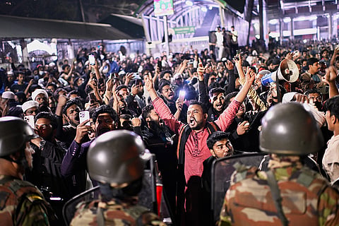Protesters shout slogans in front of the premises of the Prothom Alo daily newspaper after news reached the country from Singapore of the death of a prominent activist Sharif Osman Hadi, in Dhaka, Bangladesh.