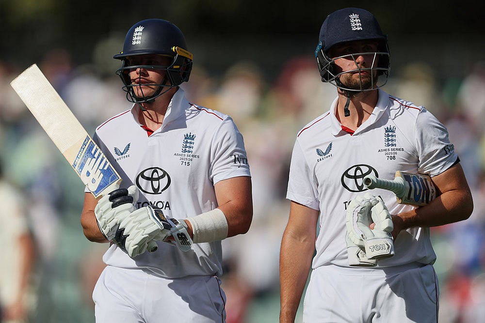 | Photo: AP/James Elsby : England's Jamie Smith, left, and Will Jacks walk from the field after play ended on day four of the third Ashes cricket test between England and Australia in Adelaide, Australia.