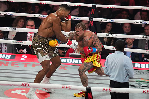 Jake Paul, right, and Anthony Joshua compete in their heavyweight boxing match in Miami, Fla.