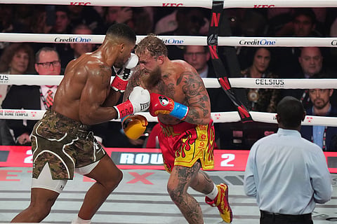 Anthony Joshua, left, in action against Jake Paul during their heavyweight boxing match in Miami, Fla.