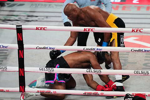 Tyron Woodley, bottom, falls to the canvas after being hit by Anderson Silva, top, during their cruiserweight fight in Miami.