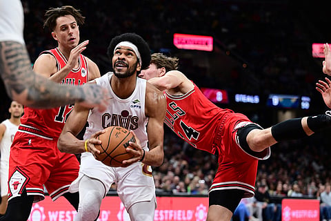 Cleveland Cavaliers center Jarrett Allen goes to the basket against Chicago Bulls forward Zach Collins, left, and Chicago Bulls forward Matas Buzelis in the second half of an NBA basketball game, in Cleveland. 