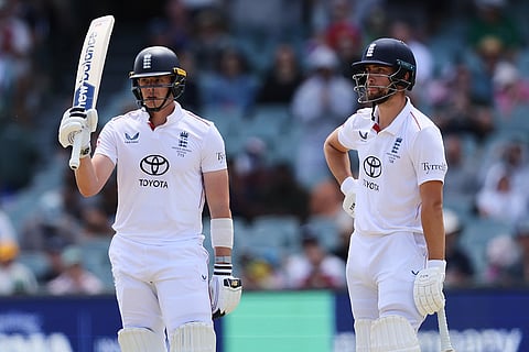England's Jamie Smith gestures with his bat on scoring 50 runs as teammate Will Jacks watches during play on the final day of the third Ashes cricket test between England and Australia in Adelaide, Australia.