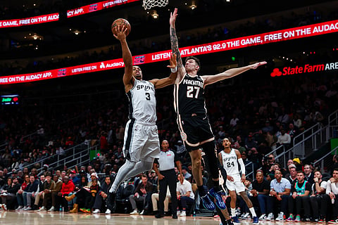 San Antonio Spurs forward Keldon Johnson (3) goes up to shoot against Atlanta Hawks guard Vit Krejci (27) during the second half of an NBA basketball game in Atlanta. 