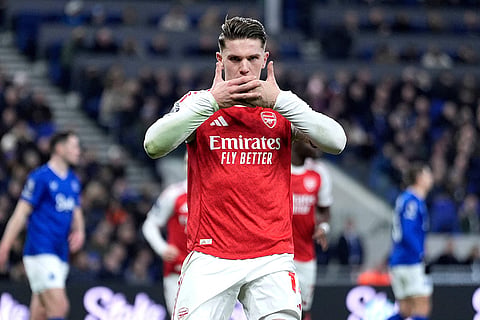 Arsenal's Viktor Gyoekeres celebrates after scoring his side's opening goal from the penalty spot during the English Premier League soccer match between Everton and Arsenal in Liverpool, England.