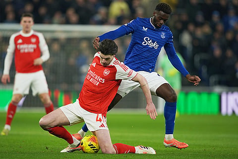 Everton's Tim Iroegbunam, top, and Arsenal's Declan Rice vie for the ball during the English Premier League soccer match between Everton and Arsenal in Liverpool, England.