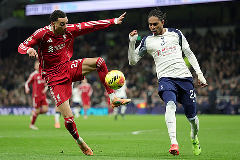 Liverpool's Hugo Ekitike, left, duels for the ball with Tottenham's Djed Spence during the English Premier League soccer match between Tottenham and Liverpool in London.