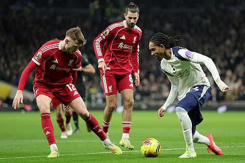 Tottenham's Djed Spence, right, duels for the ball with Liverpool's Conor Bradley, left, during the English Premier League soccer match between Tottenham and Liverpool in London.