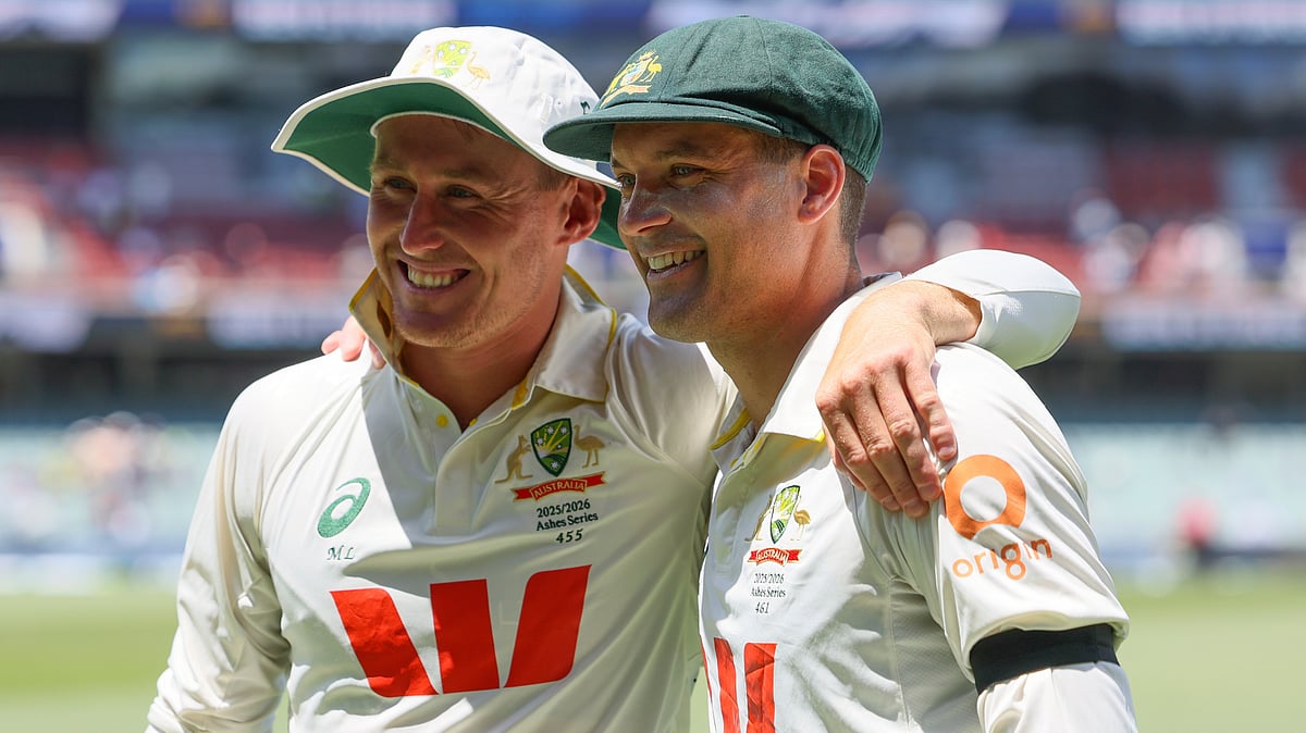 | Photo: AP/James Elsby : Australia's Alex Carey, right, and Australia's Marnus Labuschagne pose for a photo after Australia won the third Ashes Test against England in Adelaide, Australia, Sunday, Dec. 21, 2025. 