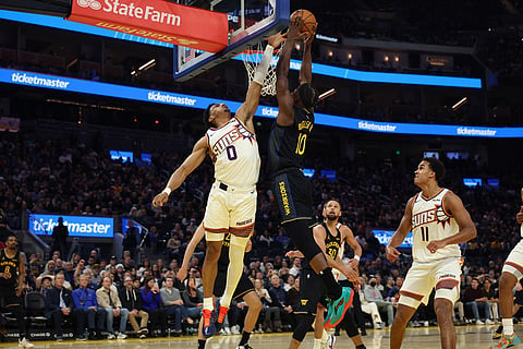 Golden State Warriors forward Jimmy Butler III (10) goes up to dunk against Phoenix Suns forward Ryan Dunn (0) during the second half of an NBA basketball game in San Francisco.