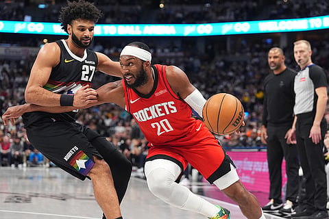 Houston Rockets guard Josh Okogie (20) drives past Denver Nuggets guard Jamal Murray (27) in the second half of an NBA basketball game in Denver. 