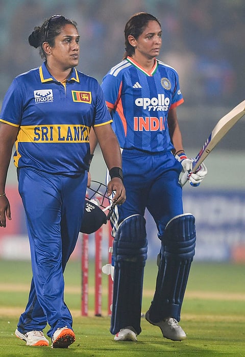 India's captain Harmanpreet Kaur with Sri Lankan counterpart Chamari Athapaththu at the end of play after India won the Women’s T20I cricket match against Sri Lanka, in Visakhapatnam, Andhra Pradesh.
