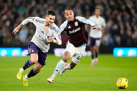 Manchester United's Diogo Dalot, left, and Aston Villa's Boubacar Kamara battle for the ball during the Premier League soccer match between Aston Villa and Manchester United, in Birmingham, England.