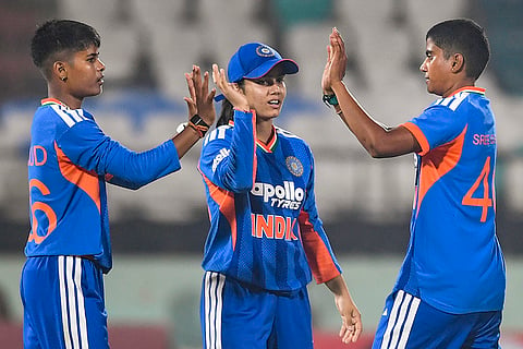 India's Kranti Gaud, left, with teammates Vaishnavi Sharma, center, and Shree Charani during the first Women's T20I cricket match between India and Sri Lanka, in Visakhapatnam, Andhra Pradesh.