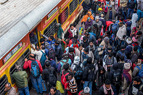 Passengers crowd the Patna railway station amid train delays and cancellations due to fog on a winter day, in Patna.