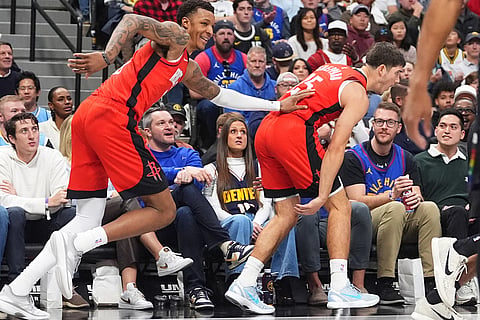 Houston Rockets forward Jabari Smith Jr., left, congratulates guard Reed Sheppard as he reacts after hitting a 3-point basket against the Denver Nuggets in the second half of an NBA basketball game in Denver. 