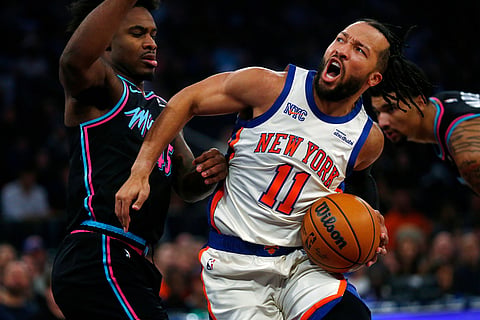 Miami Heat guard Davion Mitchell, left, defends against New York Knicks guard Jalen Brunson (11)  during the first half of an NBA basketball game in New York. 
