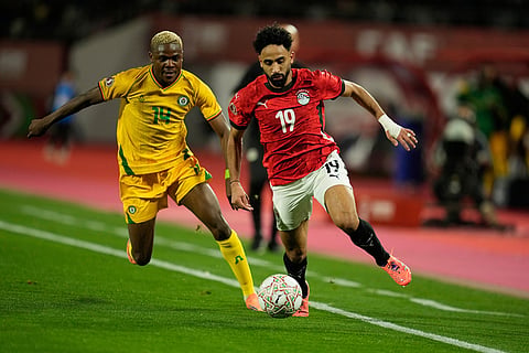 Zimbabwe's Daniel Msendami, left, and Egypt's Mostafa Fathy fight for the ball during the Africa Cup of Nations group B soccer match between Egypt and Zimbabwe in Agadir, Morocco.