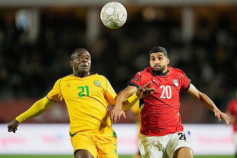 Zimbabwe's Godknows Murwira, left, and Egypt's Ibrahim Adel fight for the ball during the Africa Cup of Nations group B soccer match between Egypt and Zimbabwe in Agadir, Morocco.