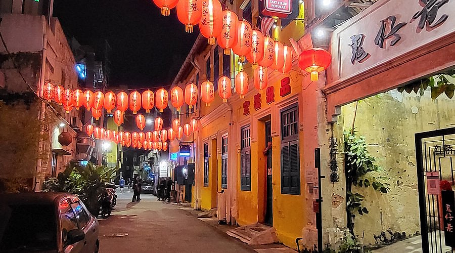Night scene of Kwai Chai Hong alley in Kuala Lumpur illuminated by rows of red Chinese lanterns