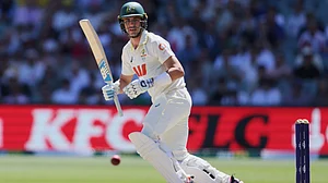 | Photo: AP/James Elsby : Australia's Pat Cummins bats during play on day four of the third Ashes cricket test between England and Australia in Adelaide, Australia, Saturday, Dec. 20, 2025.