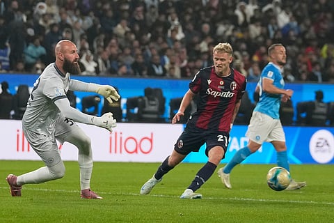 Napoli's Vanja Milinkovic-Savic, left, passes the ball during the Italian Super Cup final soccer match between Napoli and Bologna in Riyadh, Saudi Arabia.