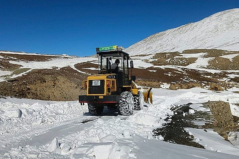 Project Management Unit (PMU) worker clears accumulated snow to restore road connectivity, at Daksum–Sinthan in Anantnag.