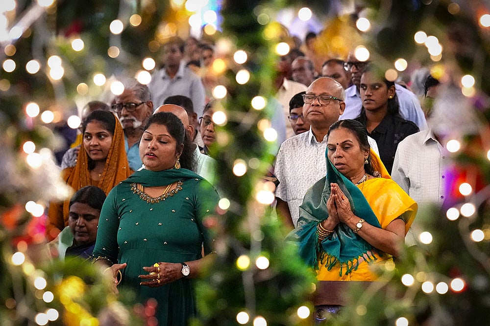 | Photo: PTI/R SenthilKumar : Christian devotees offer prayers during the Christmas morning service at Santhome Cathedral Basilica church, in Chennai.