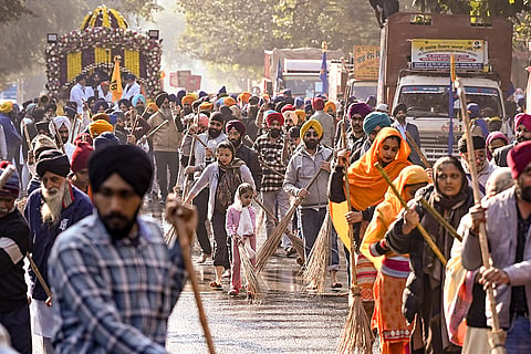People participate in a 'Nagar Kirtan' organised by Delhi Sikh Gurdwara Management Committee (DSGMC) as part celebrations of Guru Gobind Singh's Parkash Purab, near Gurdwara Rakab Ganj Sahib, in New Delhi.