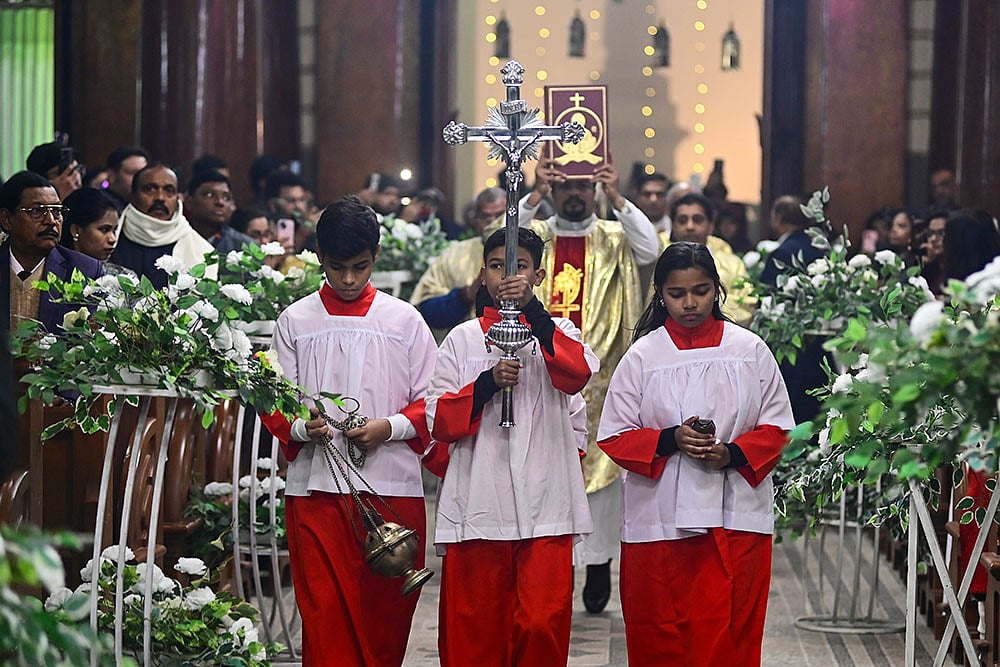 Photo: PTI : Prayagraj: People from the Christian community during the Christmas midnight mass at St. Joseph's Cathedral, in Prayagraj, Wednesday night, Dec. 24, 2025. (PTI Photo)(PTI12_25_2025_000019B)