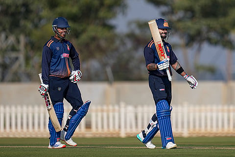 Delhi's Virat Kohli, right, celebrates his century during the Vijay Hazare Trophy 2025-26 cricket match between Andhra and Delhi, at BCCI Centre of Excellence Ground, in Bengaluru.