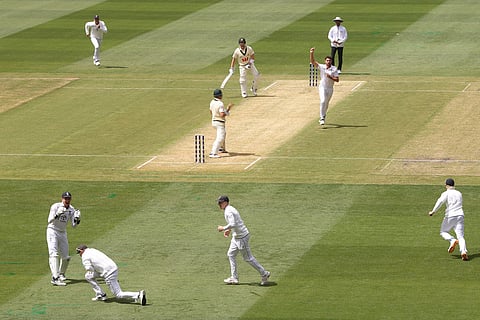 England's Joe Root, second left, catches out Australia's Marnus Labuschagne, center, during their Ashes cricket test match in Melbourne.