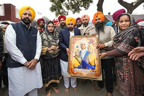 Punjab Chief Minister Bhagwant Mann, centre, being felicitated on 'Veer Bal Diwas', observed to mark the martyrdom anniversary of the sons of tenth Sikh Guru, Guru Gobind Singh, at Sri Fatehgarh Sahib, in Punjab. 