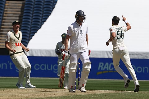 Australia's Mitchell Starc, right, celebrates the wicket of England's Zak Crawley, center, during their Ashes cricket test match in Melbourne.
