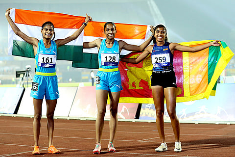 India’s Amandeep Kaur, center, and compatriot Thota Sankeertana with Sri Lanka’s Kodithuwakku Takshi after winning in the women’s 800m final event during the 4th South Asian (SAAF) Senior Athletics Championships, at the Birsa Munda Athletics Stadium, in Ranchi, Jharkhand, Sunday, Oct. 26, 2025. 