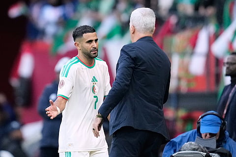 Algeria's Riyad Mahrez shakes hands with Algeria's head coach Vladimir Petkovic after being substituted during the Africa Cup of Nations group E soccer match between Algeria and Sudan in Rabat, Morocco.