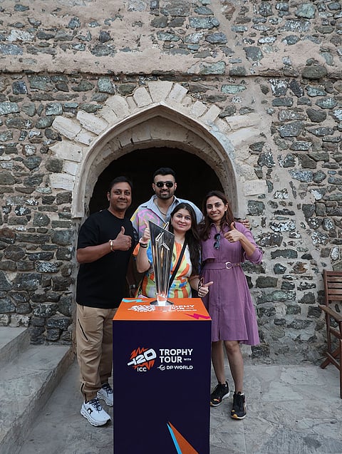 Fans pose with the ICC Men’s T20 World Cup 2026 trophy at Muttrah Fort during the trophy tour in Oman