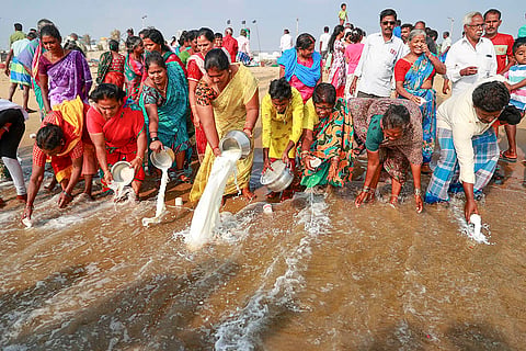 People pour milk as part of rituals to pay tribute to the victims of the 2004 tsunami on the 21st anniversary of the tragedy, at Pattinapakkam beach, in Chennai.
