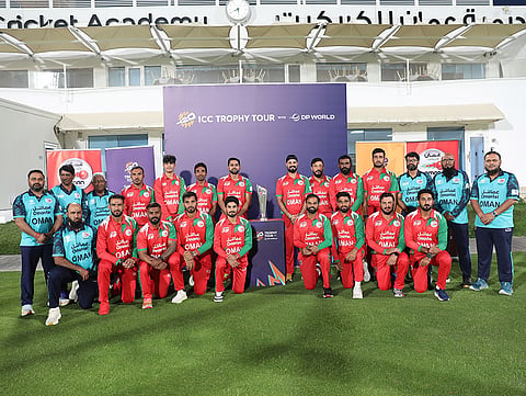 The Oman senior men’s cricket team poses with the ICC Men’s T20 World Cup 2026 trophy at the Oman Cricket Academy during the trophy tour in Oman