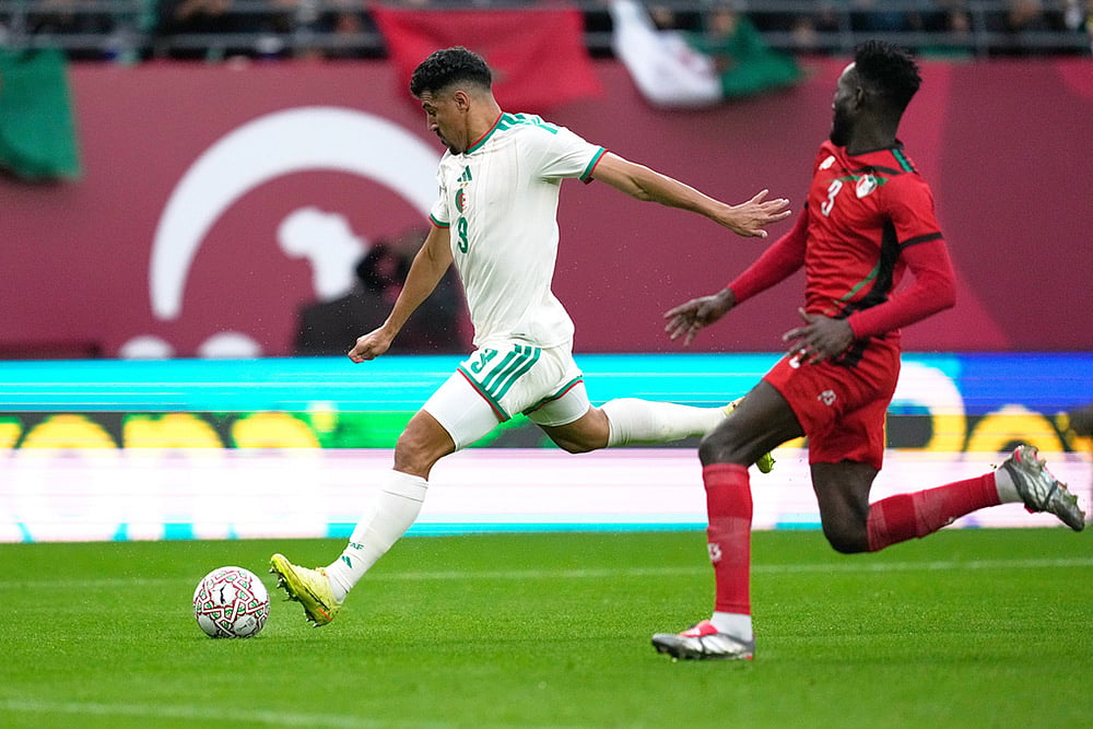 | Photo: AP/Mosa'ab Elshamy : Algeria's Baghdad Bounedjah attempts a shot next to Sudan's Mohamed Saeed Ahmed during the Africa Cup of Nations group E soccer match between Algeria and Sudan in Rabat, Morocco.