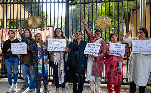 Agitators, including women activists, hold placards as they stage a protest against the suspension of the jail term of Kuldeep Sengar, a former BJP MLA who was convicted in the Unnao rape case, outside the Delhi High Court, in New Delhi.