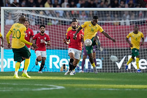 South Africa's Mbekezeli Mbokazi is challenged by Egypt's Mohamed Salah during the Africa Cup of Nations group B soccer match between Egypt and South Africa in Agadir, Morocco.