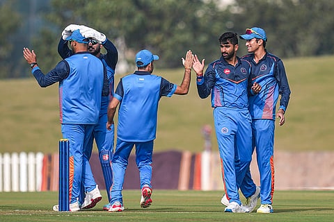 Gujarat's Chintan Gaja with teammates celebrates after taking the wicket of Delhi's Priyansh Arya during the Vijay Hazare Trophy 2025-26 cricket match between Gujarat and Delhi, at BCCI Centre of Excellence Ground, in Bengaluru.