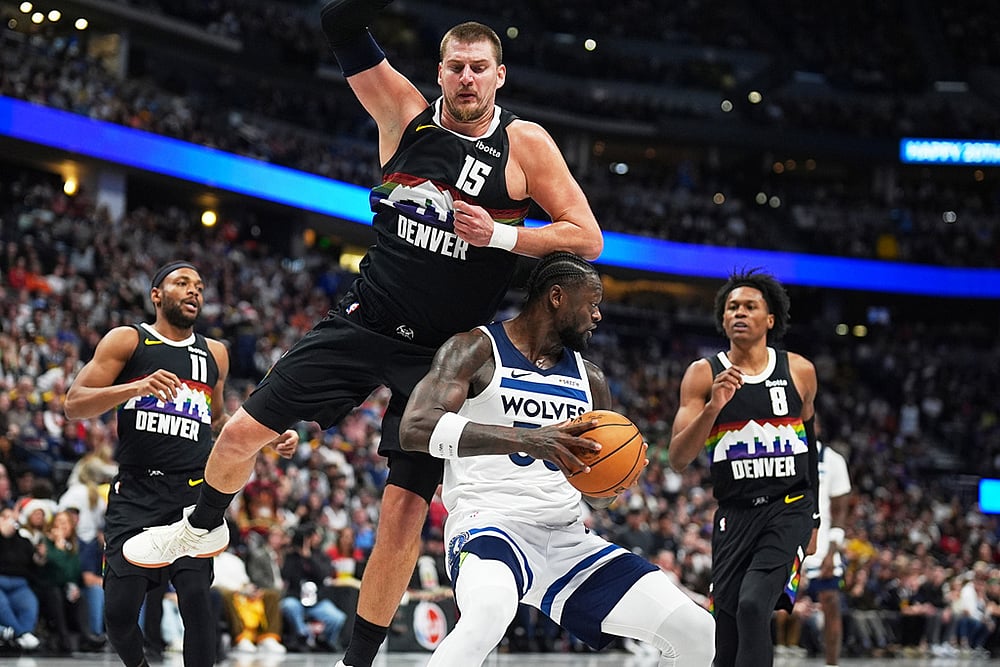 | Photo: AP/David Zalubowski : Minnesota Timberwolves center Julius Randle, foreground bottom, takes an elbow to the top of his head from Denver Nuggets center Nikola Jokić, front top, as guards Bruce Brown, back left, and Peyton Watson defend in the second half of an NBA basketball game in Denver. 