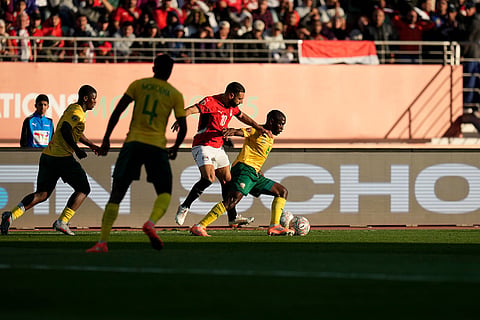 South Africa's Aubrey Modiba is challenged by Egypt's Mohamed Salah during the Africa Cup of Nations group B soccer match between Egypt and South Africa in Agadir, Morocco.