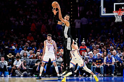 San Antonio Spurs forward/center Victor Wembanyama (1) looks to pass against the Oklahoma City Thunder during the second half of an NBA basketball game, in Oklahoma City.