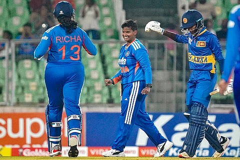 India’s Deepti Sharma, centre, celebrates a wicket with Richa Ghosh, left, during the third T20 International cricket match of a series between India Women and Sri Lanka Women, at Greenfield International Stadium, in Thiruvananthapuram, Kerala.
