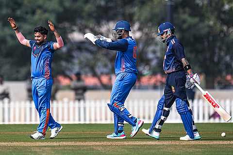 Gujarat's Vishal Jayswal, left, with teammate celebrates after taking the wicket of Delhi's Virat Kohli during the Vijay Hazare Trophy 2025-26 cricket match between Gujarat and Delhi, at BCCI Centre of Excellence Ground, in Bengaluru.